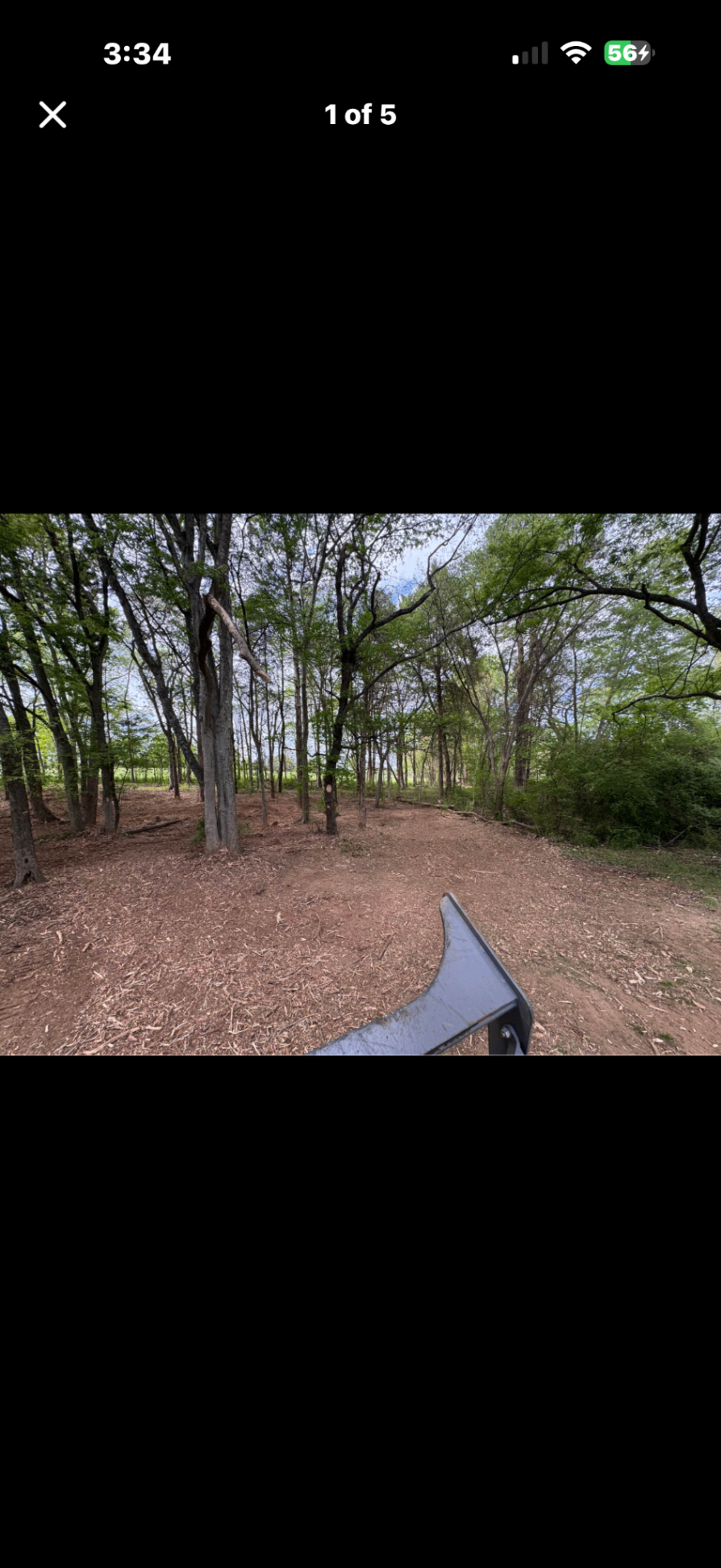 Forestry mulching in progress — wooded lot with mulched ground