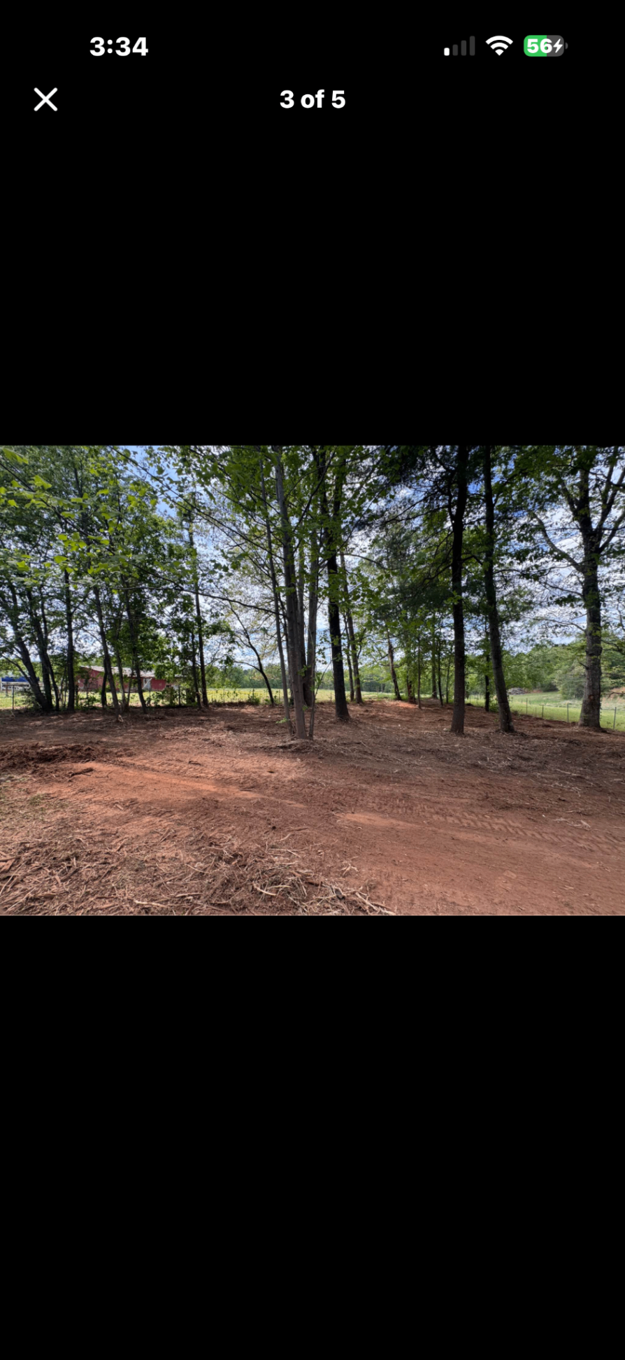 Cleared land with red clay soil and pine tree line — North Carolina